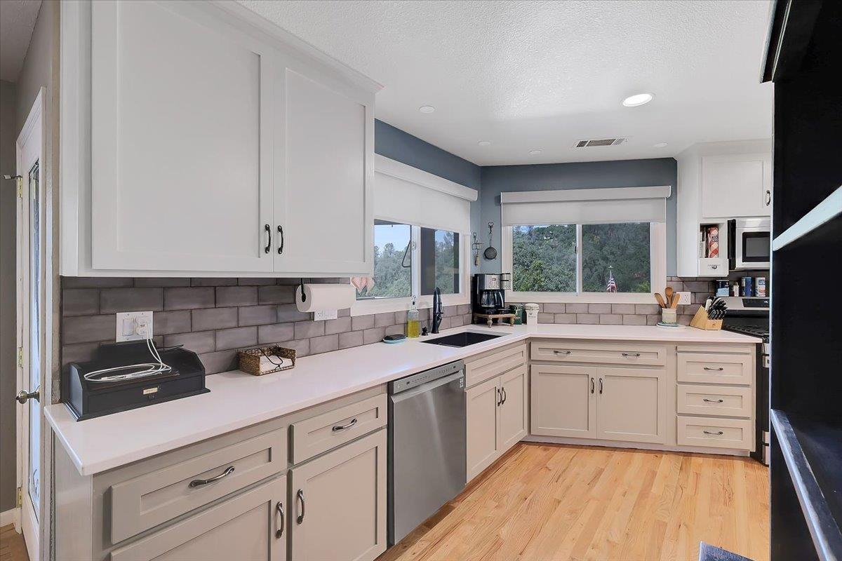 9521 Sicard Flat Road Browns Valley, CA 95918 - Photo 22 of 83 a kitchen with a sink stove and cabinets