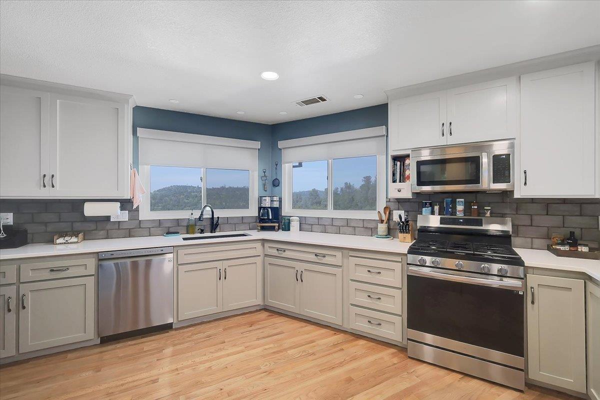 9521 Sicard Flat Road Browns Valley, CA 95918 - Photo 25 of 83 a kitchen with a sink stove and microwave