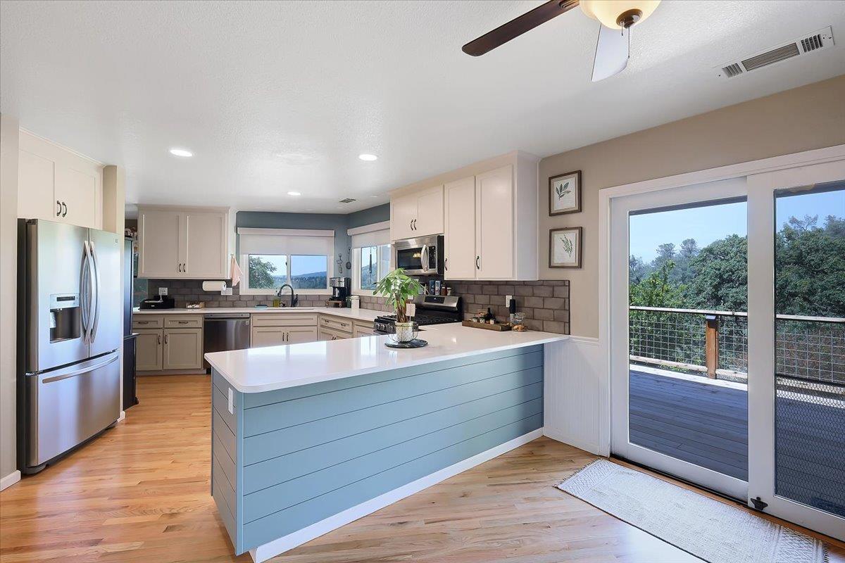9521 Sicard Flat Road Browns Valley, CA 95918 - Photo 27 of 83 a large kitchen with kitchen island a large counter top space a sink stainless steel appliances and cabinets