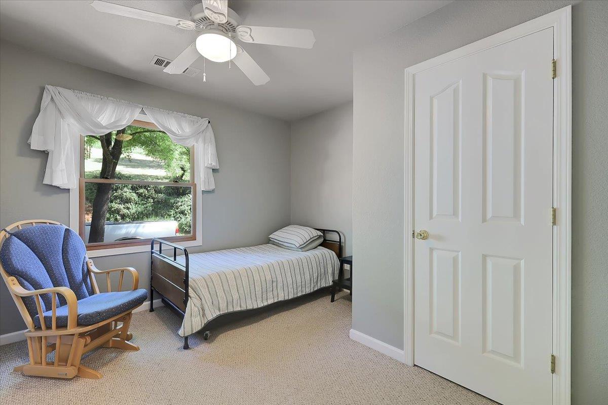 9521 Sicard Flat Road Browns Valley, CA 95918 - Photo 35 of 83 a bedroom with a bed and a chandelier
