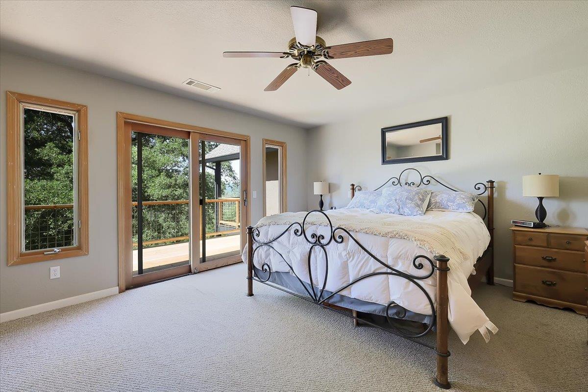 9521 Sicard Flat Road Browns Valley, CA 95918 - Photo 39 of 83 a spacious bedroom with a bed and a large window