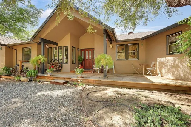 a view of a house with backyard and sitting area