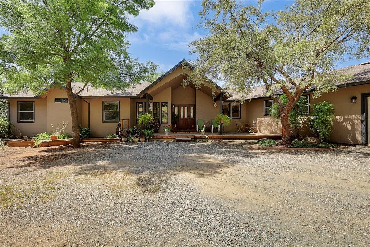 9521 Sicard Flat Road Browns Valley, CA 95918 - Photo 4 of 83 a backyard of a house with table and chairs under an umbrella
