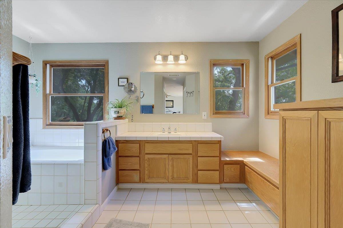 9521 Sicard Flat Road Browns Valley, CA 95918 - Photo 44 of 83 a bathroom with a sink a vanity and mirror