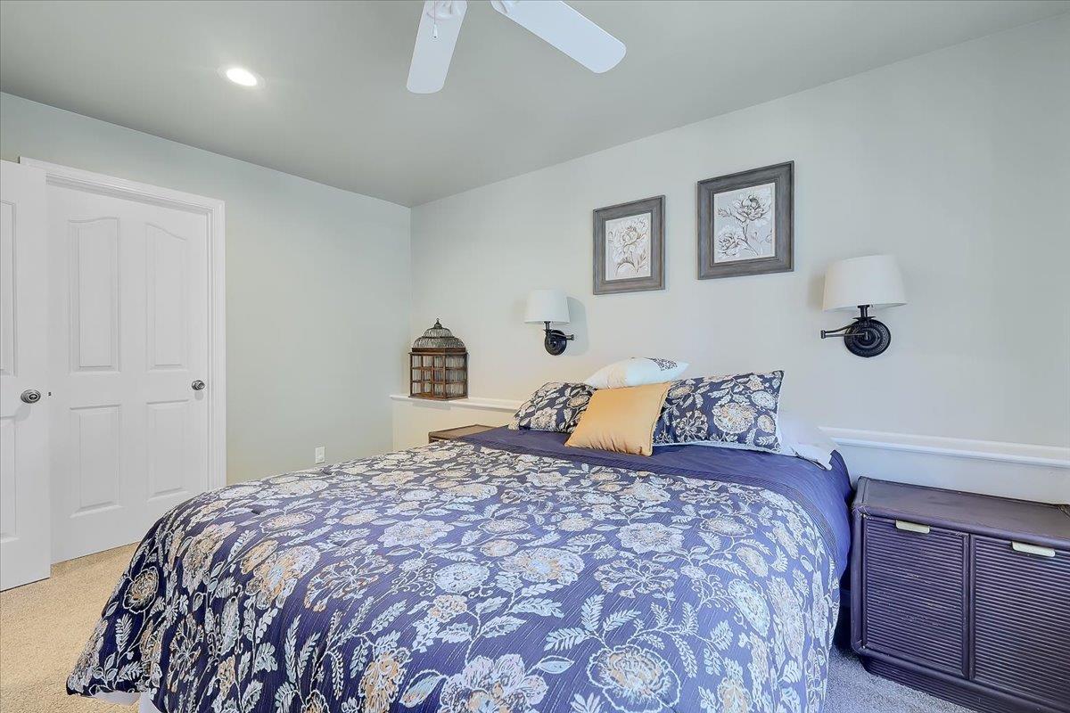 9521 Sicard Flat Road Browns Valley, CA 95918 - Photo 52 of 83 a bedroom with a large bed and a chandelier