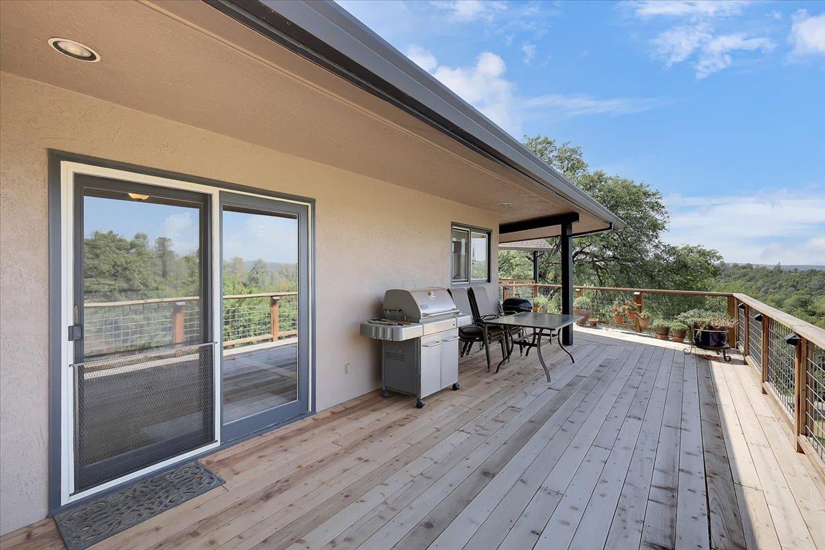 9521 Sicard Flat Road Browns Valley, CA 95918 - Photo 57 of 83 a view of a patio with table and chairs potted plants with wooden floor
