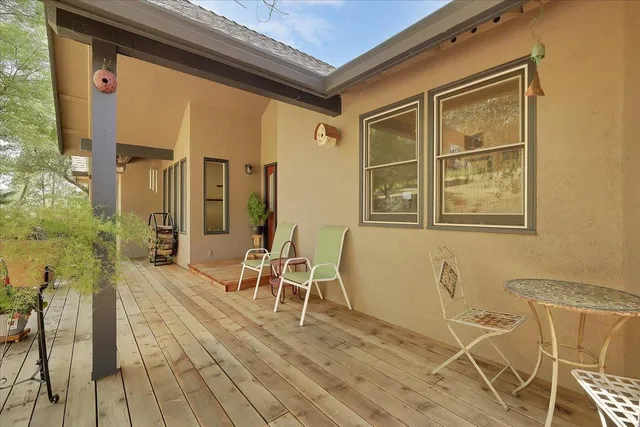 a living room with furniture floor to ceiling window and a flat screen tv