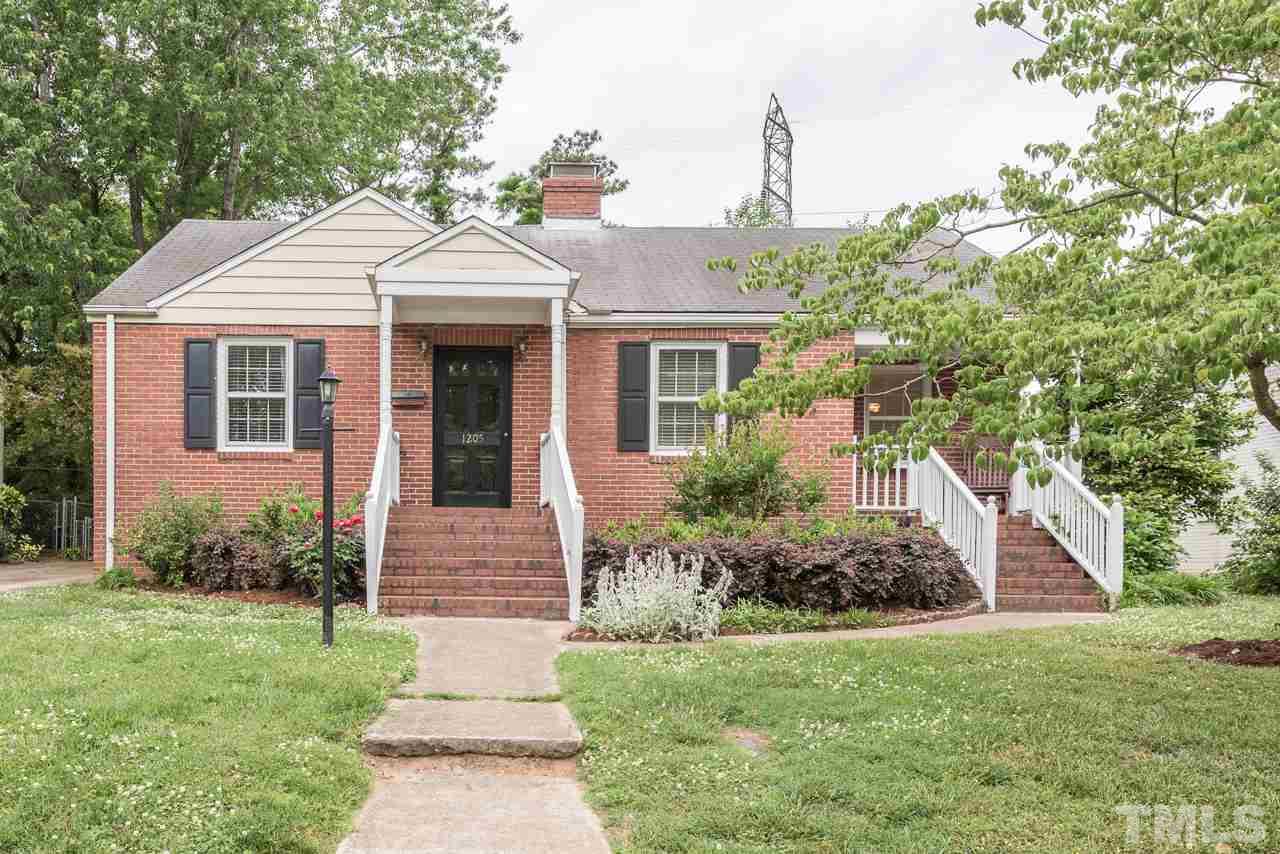 1205 Mitchell Street Raleigh, NC 27607 - Photo 1 of 25 a front view of a house with a garden