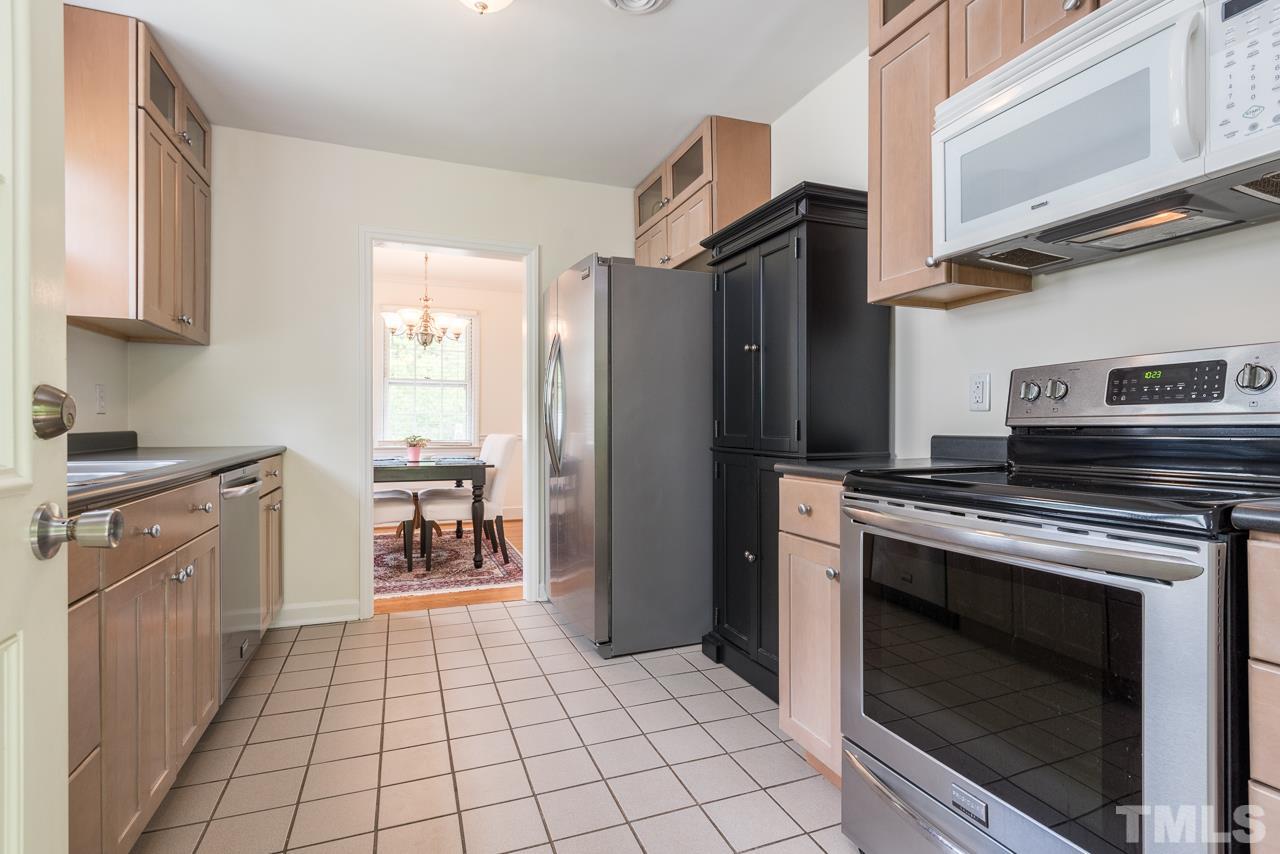 1205 Mitchell Street Raleigh, NC 27607 - Photo 14 of 25 a kitchen with a stove top oven and cabinets
