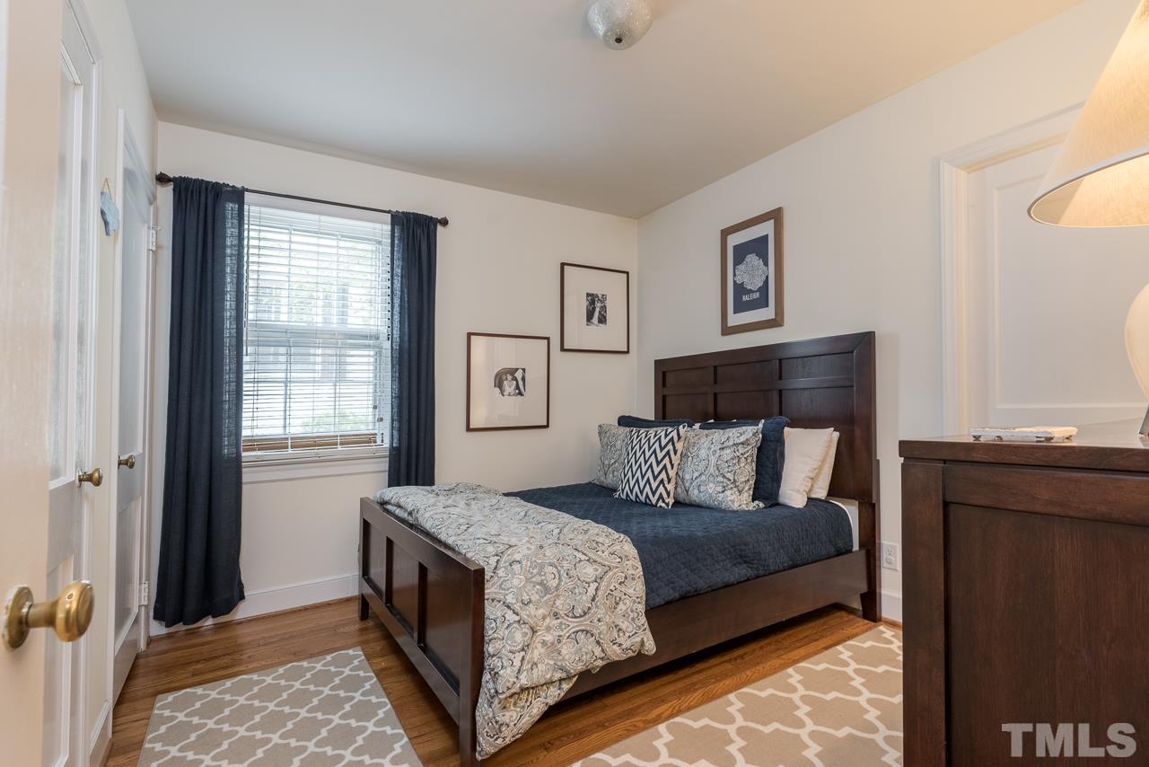 1205 Mitchell Street Raleigh, NC 27607 - Photo 3 of 25 a bedroom with a bed and a window