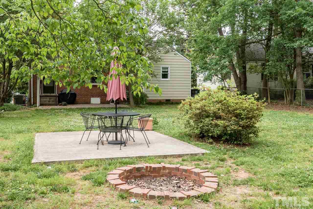 1205 Mitchell Street Raleigh, NC 27607 - Photo 23 of 25 a view of a chair and table in backyard of the house