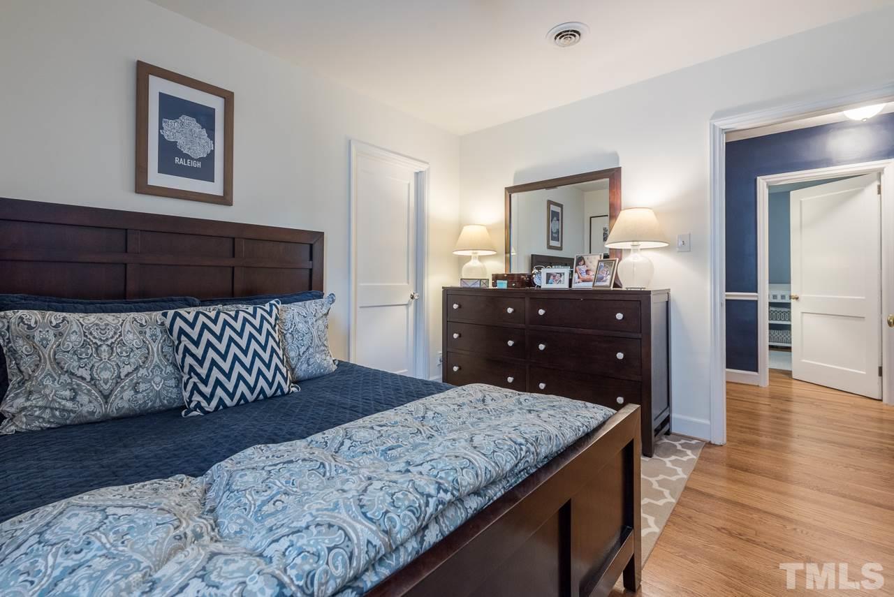 1205 Mitchell Street Raleigh, NC 27607 - Photo 4 of 25 a bedroom with a bed and wooden floor