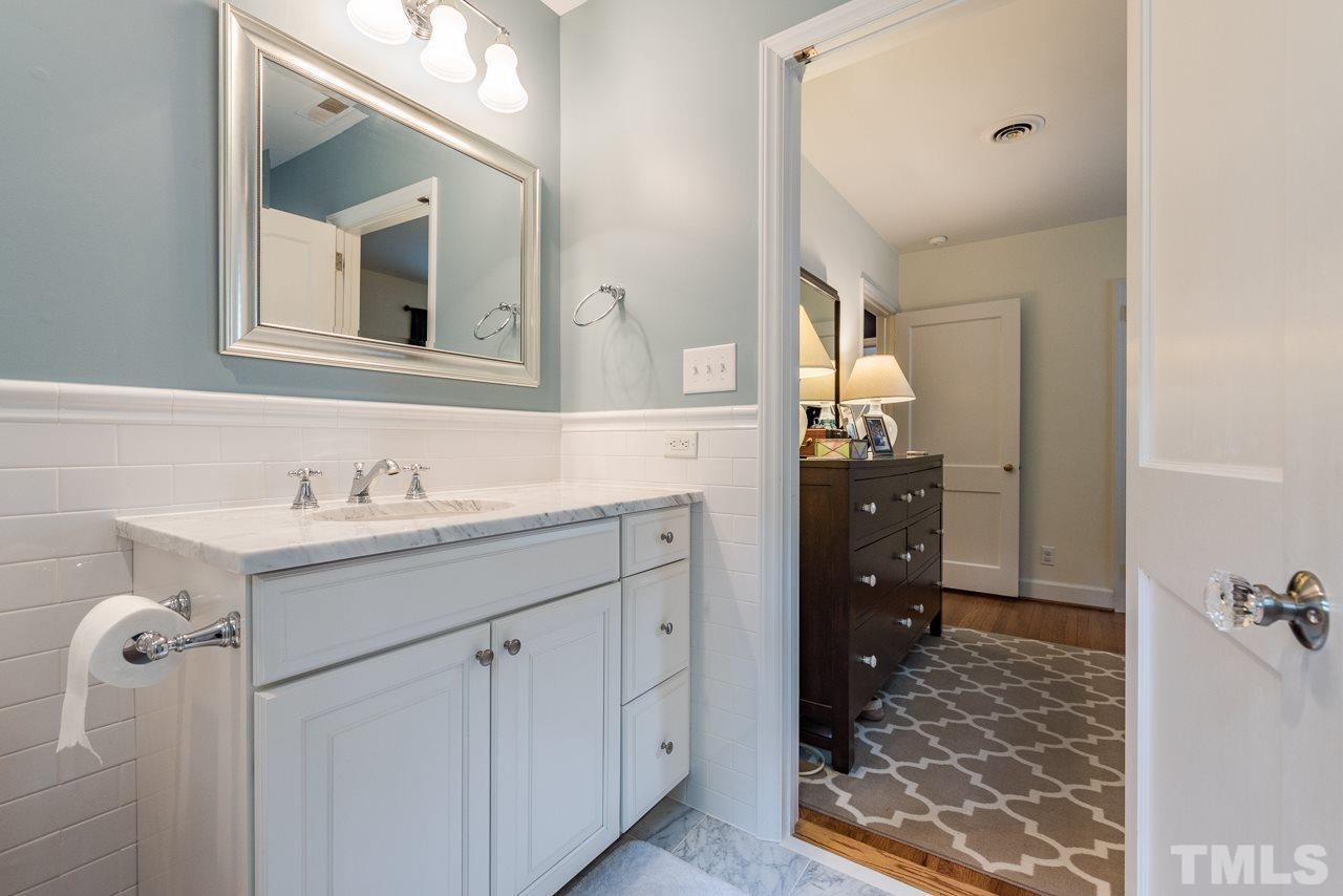1205 Mitchell Street Raleigh, NC 27607 - Photo 6 of 25 a bathroom with a sink vanity and mirror