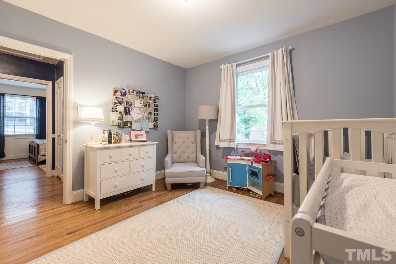 1205 Mitchell Street Raleigh, NC 27607 - Photo 8 of 25 a bed room with furniture and a window