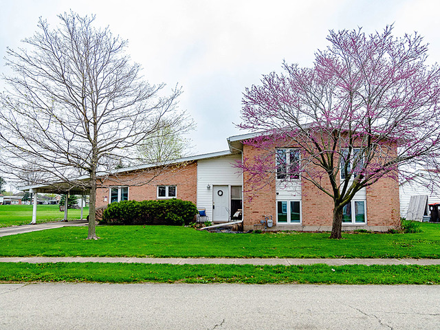 1550 South Pointe Drive Rantoul, IL 61866 - Photo 1 of 54 a front view of a house with a yard and trees