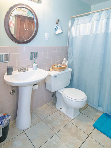 1550 South Pointe Drive Rantoul, IL 61866 - Photo 35 of 54 a bathroom with a toilet a sink and a mirror