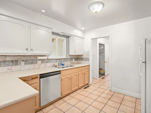 a kitchen with a sink window and cabinets