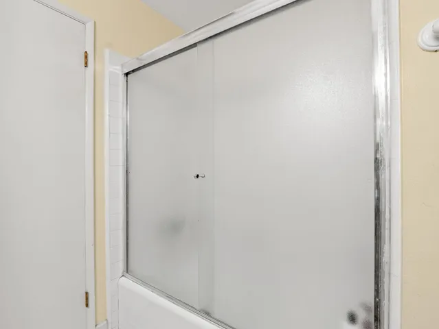 a bathroom with a glass shower door
