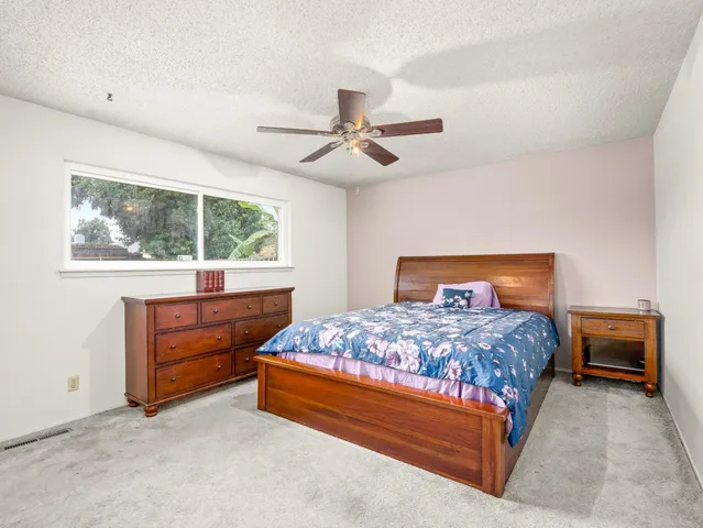 a bedroom with a bed and a table