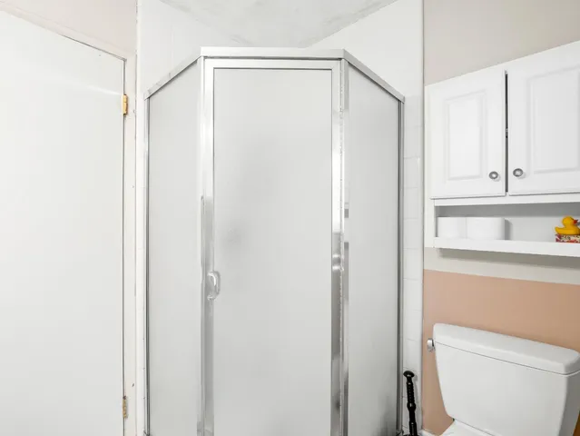 a bathroom with a shower a toilet and a sink