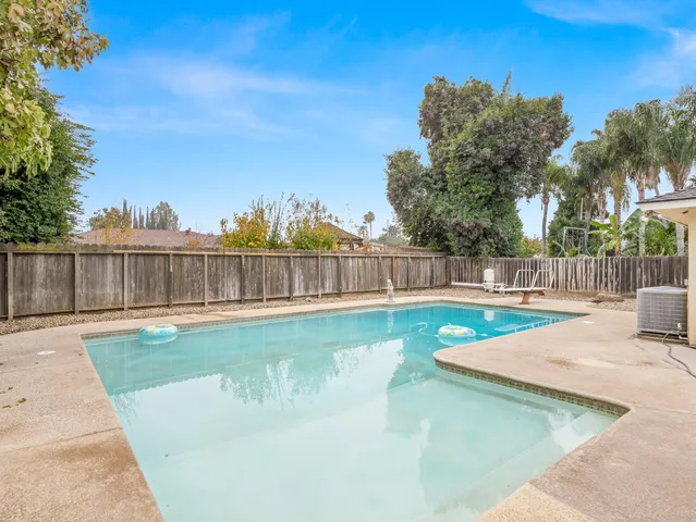 a view of a swimming pool with a yard