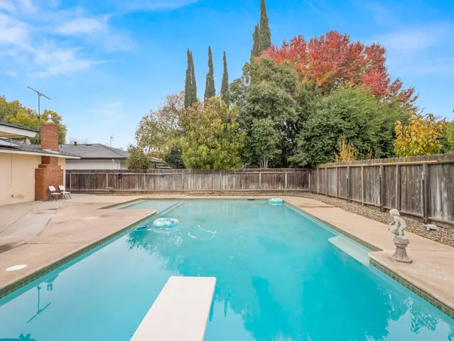a backyard of a house with table and chairs