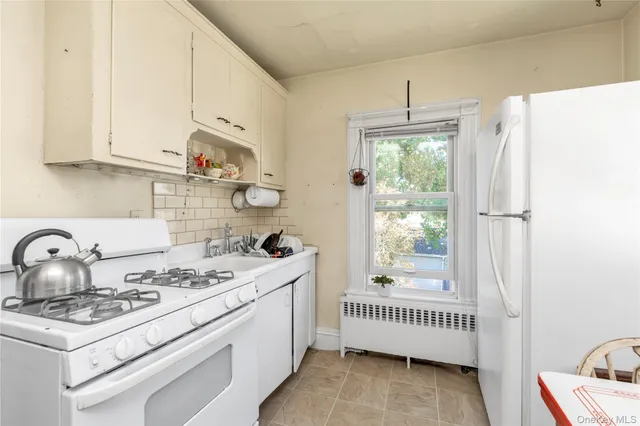 a kitchen with a stove a refrigerator and a sink