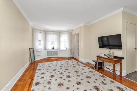 a bedroom with furniture and a flat screen tv