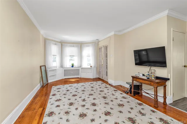a bedroom with furniture and a flat screen tv