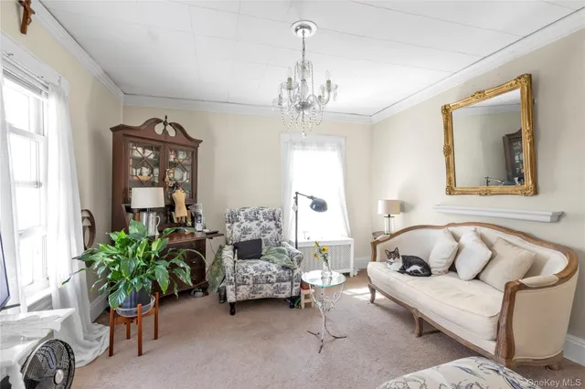 a living room with furniture and a chandelier