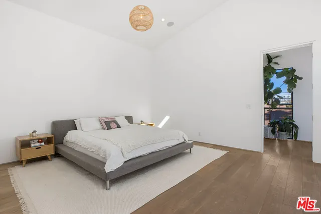 a bedroom with a bed and a chair