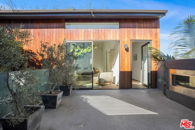 a bathroom with a tub potted plant and a sink