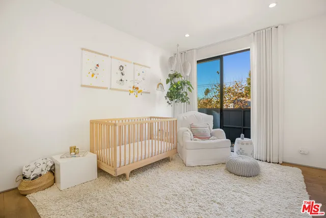 a living room with furniture a flat screen tv and a floor to ceiling window
