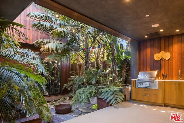 a lobby with furniture and potted plants