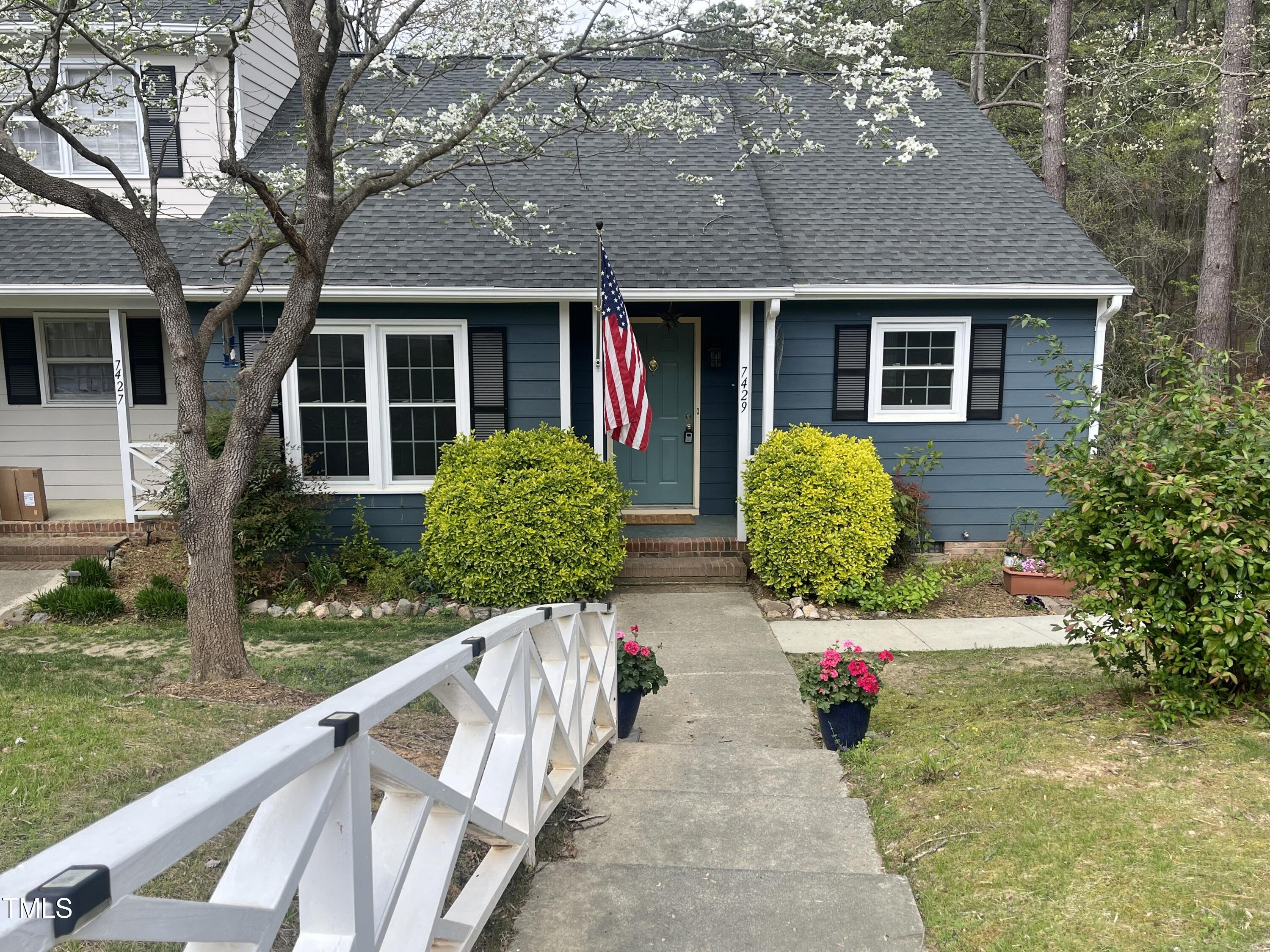 a front view of house with yard and green space