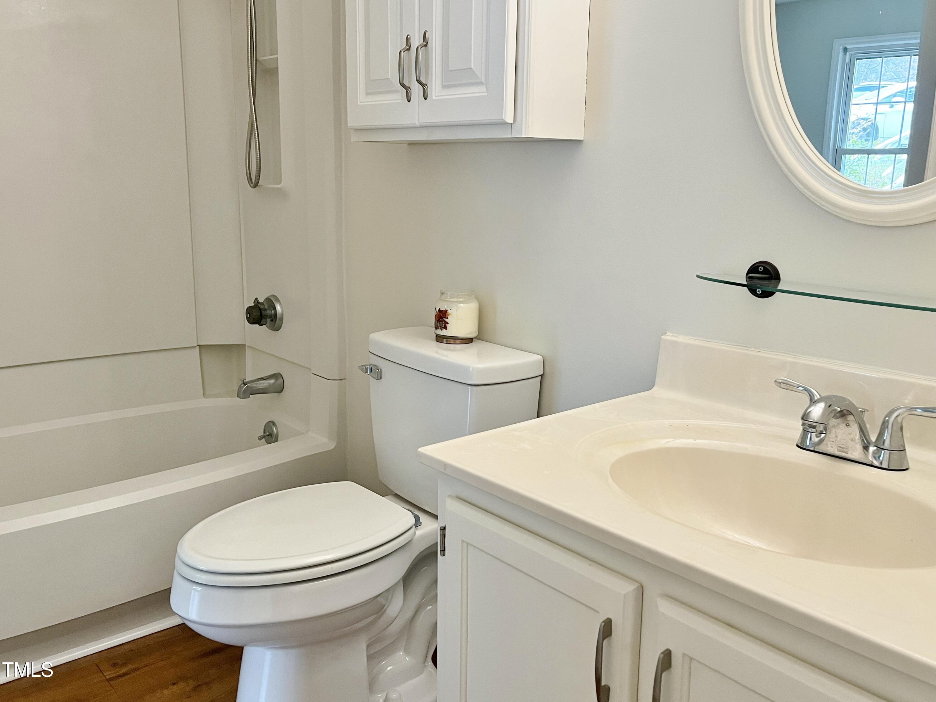 7429 Ashbury Court Raleigh, NC 27615 - Photo 12 of 16 a bathroom with a sink a toilet and shower