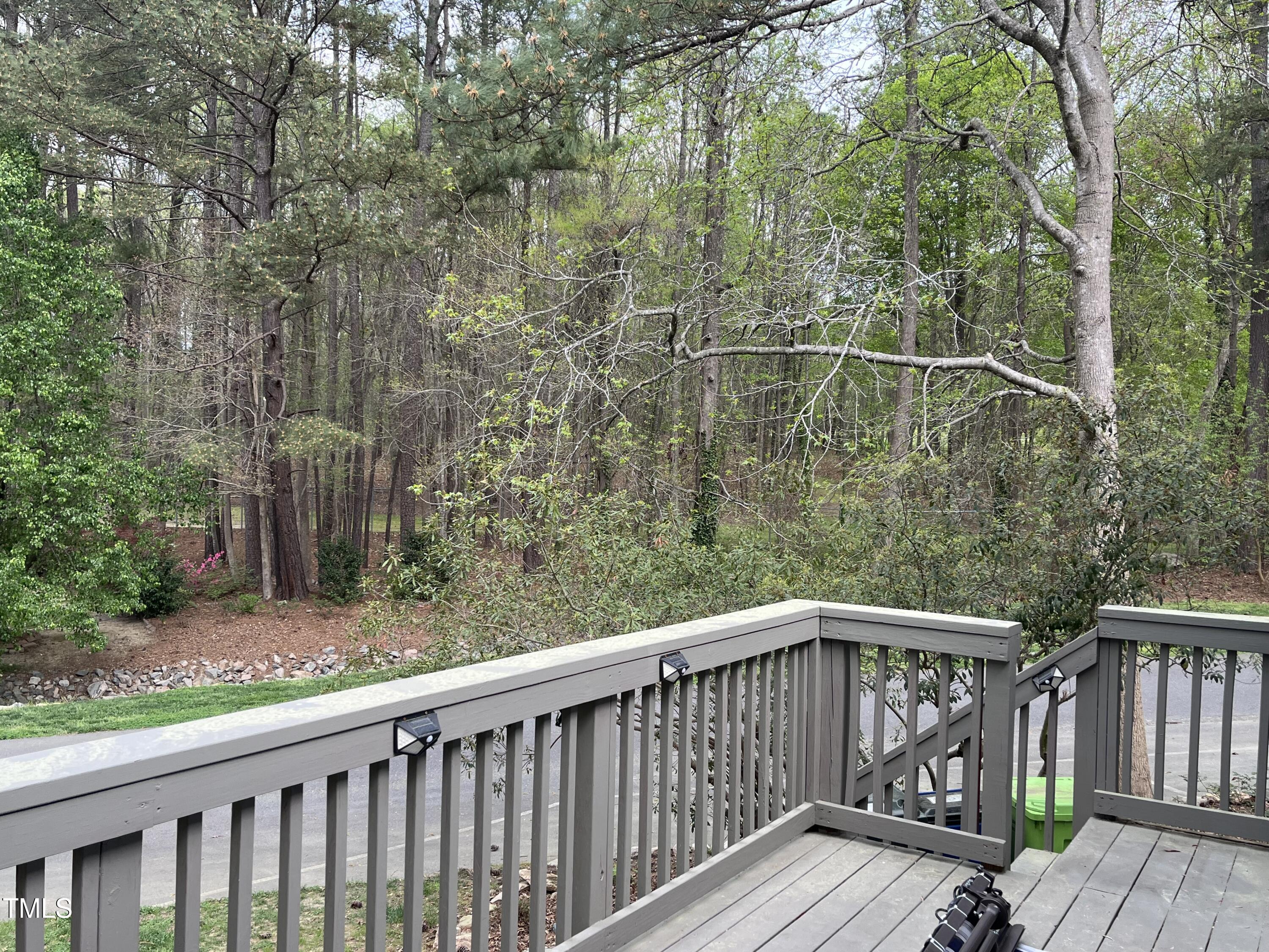7429 Ashbury Court Raleigh, NC 27615 - Photo 15 of 16 a balcony with trees in front of it