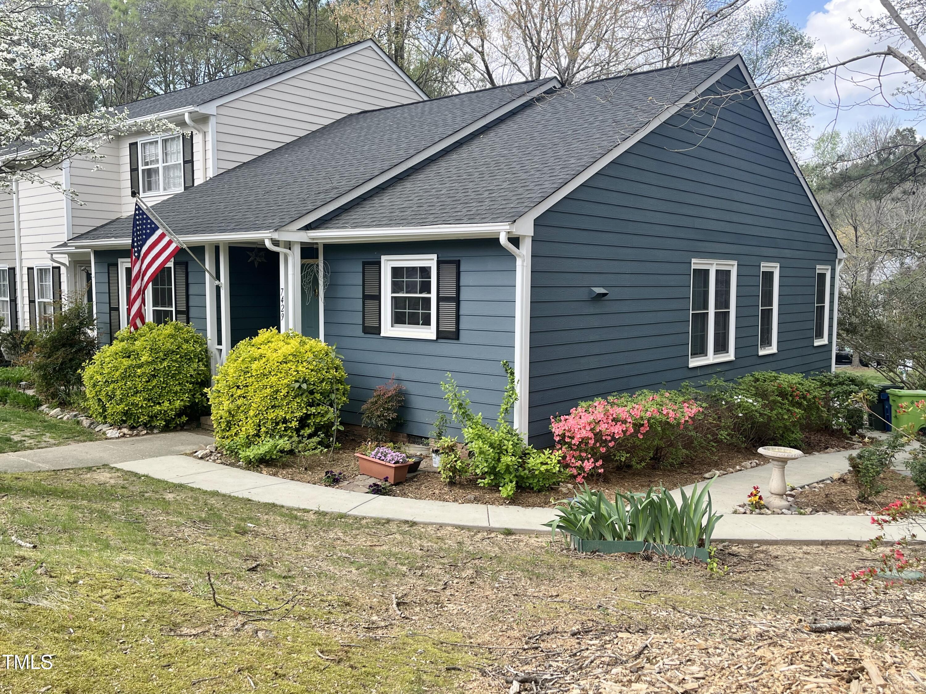 7429 Ashbury Court Raleigh, NC 27615 - Photo 2 of 16 a view of a house with a yard and potted plants