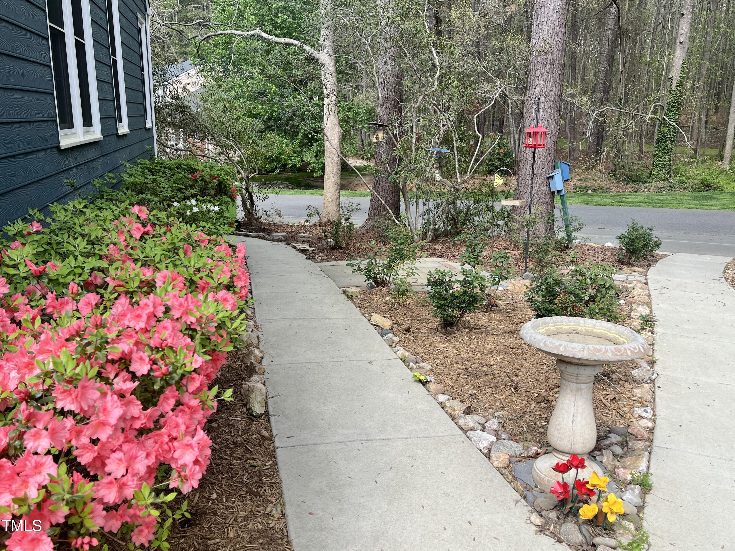 7429 Ashbury Court Raleigh, NC 27615 - Photo 3 of 16 a front view of a house with fountain