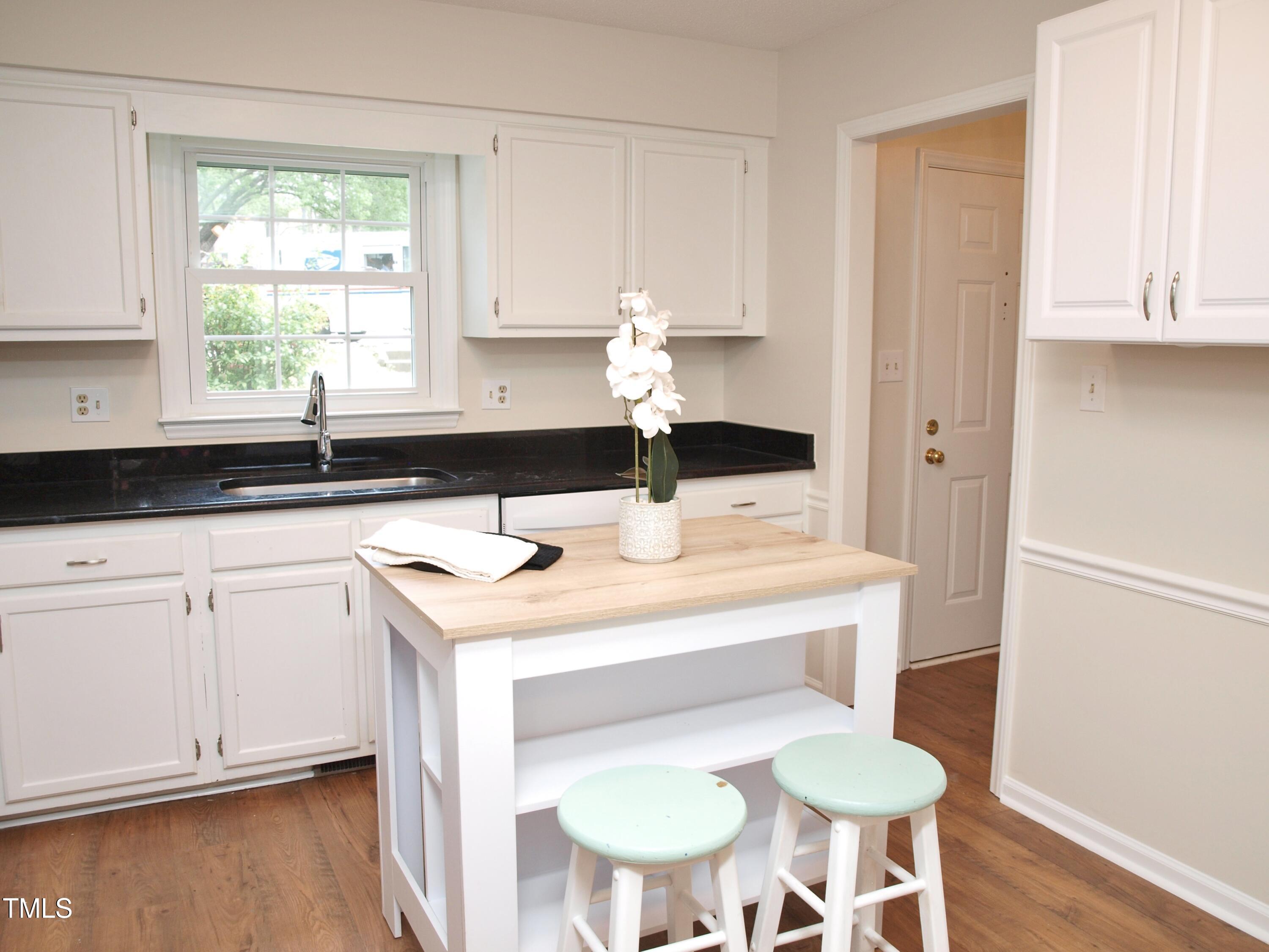 7429 Ashbury Court Raleigh, NC 27615 - Photo 5 of 16 a kitchen with a sink cabinets and wooden floor