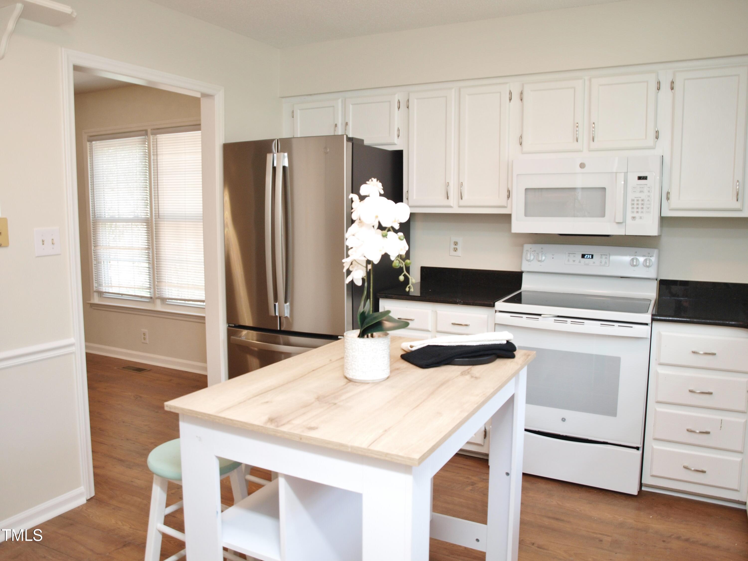 7429 Ashbury Court Raleigh, NC 27615 - Photo 6 of 16 a kitchen with a stove a refrigerator and cabinets