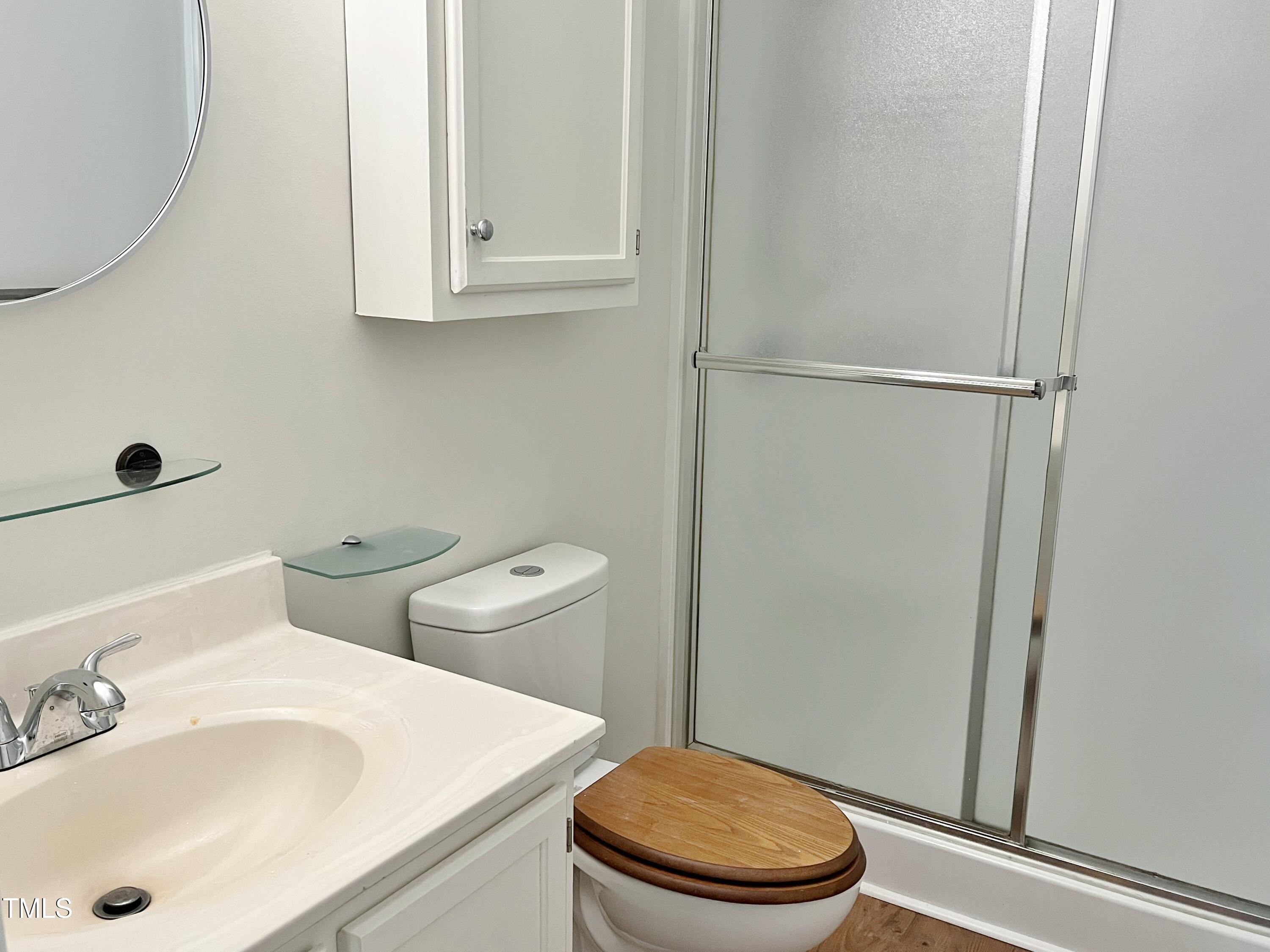 7429 Ashbury Court Raleigh, NC 27615 - Photo 10 of 16 a white toilet sitting next to a bathroom sink