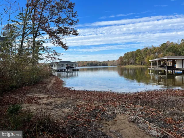 a view of a lake with houses in the back