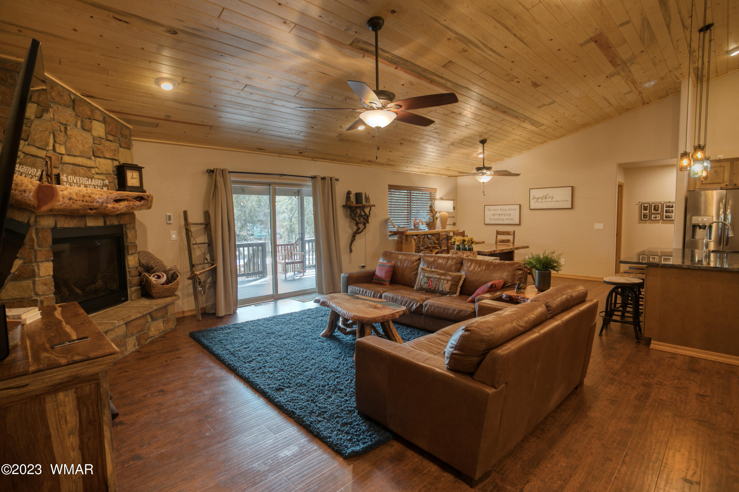 1979 Rim View Lane Heber, AZ 85928 - Photo 4 of 27 a living room with couches a flat screen tv and kitchen view