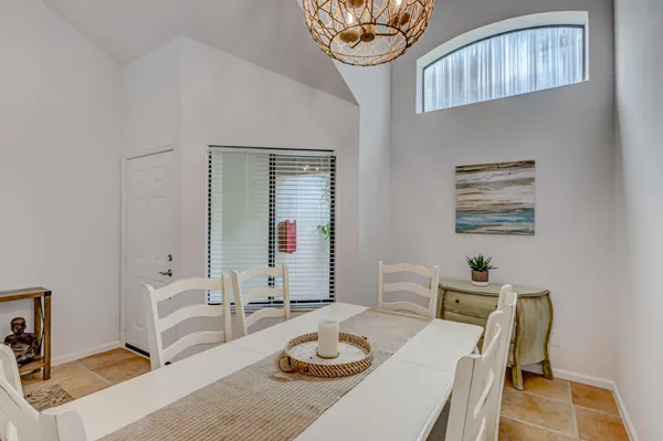 a view of a dining room with furniture wooden floor and a chandelier