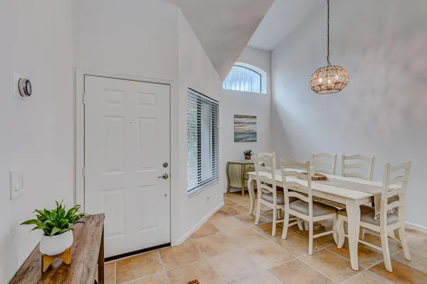 a room with furniture a mirror and a potted plant