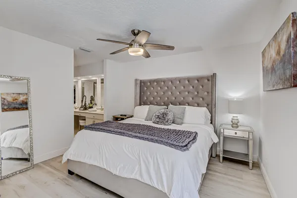 a bedroom with a large bed and a window