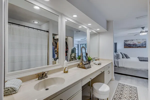a bathroom with double vanity sinks and a mirror