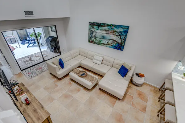 a living room with furniture and a potted plant
