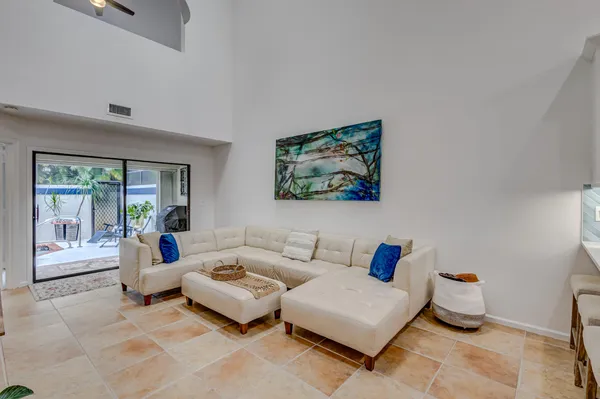 a living room with furniture and a potted plant